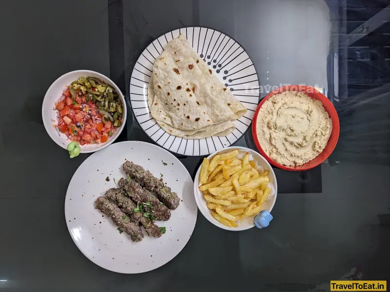 Easy, home-made beef kebab wraps with hummus and french fries